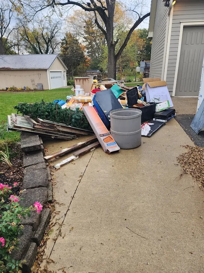 Dumpster being loaded with debris for 12 Yard Dumpster Rental in Delaware